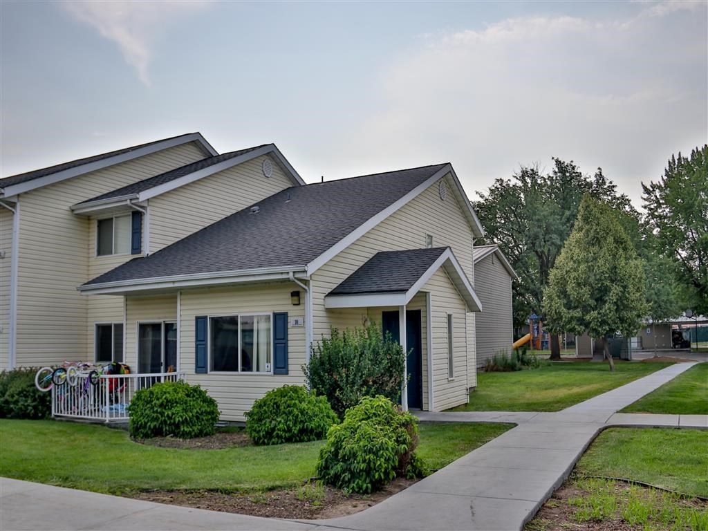a white house with a sidewalk in front of it