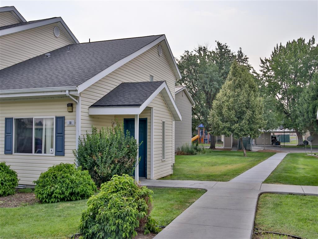 a white house with a sidewalk in front of it