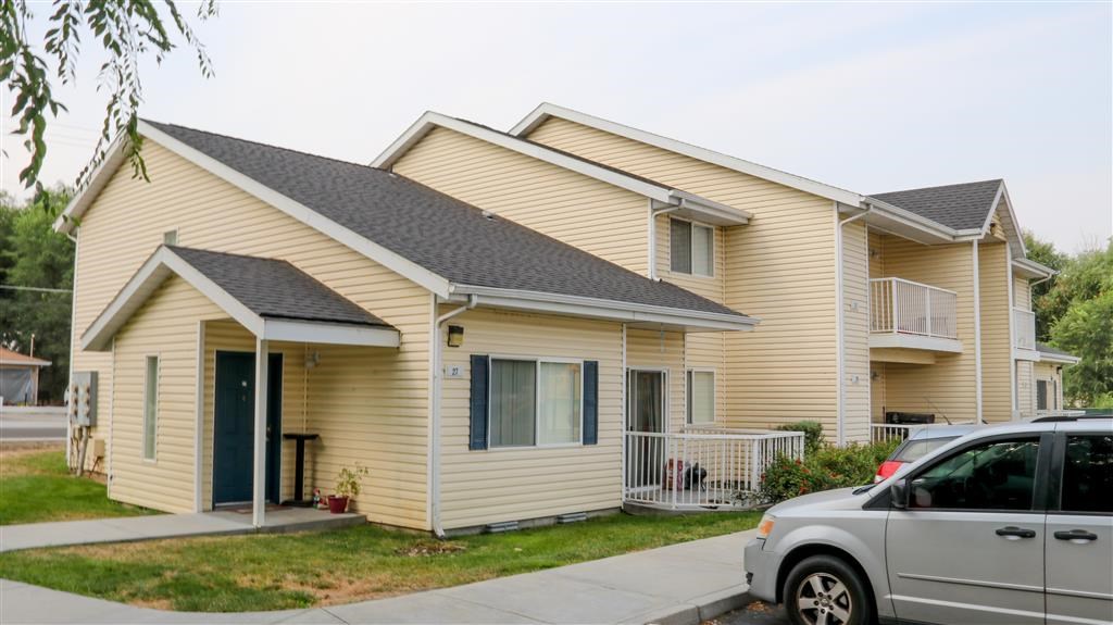 a yellow house with a van parked in front of it