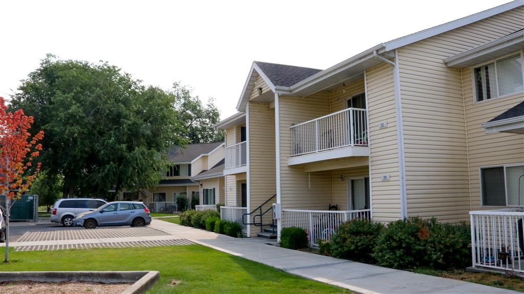 an apartment building with cars parked in front of it