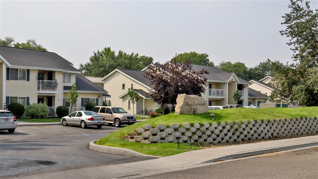 a row of houses with cars parked in front of them