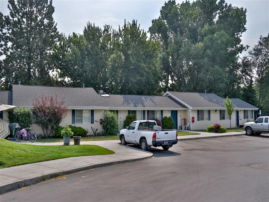a white truck parked in front of a white house