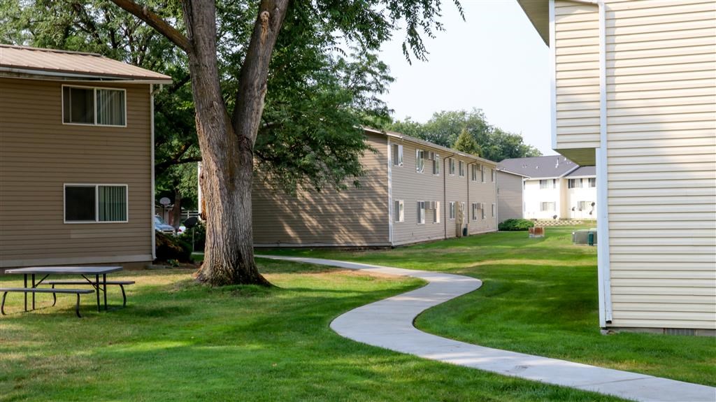 a sidewalk leading to a row of houses