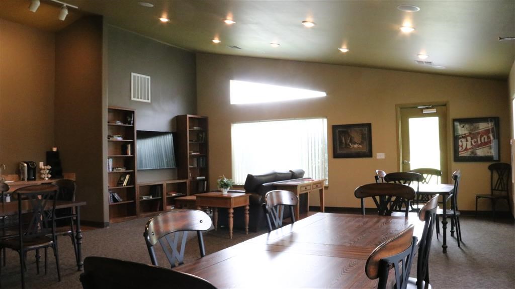 a living room with a wooden table and chairs