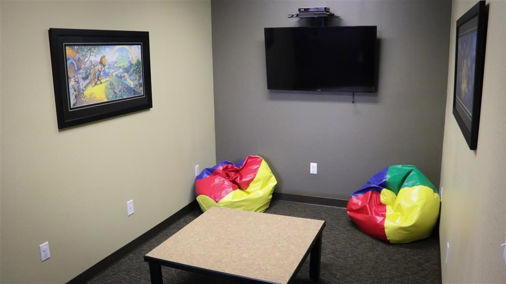 a room with three bean bags and a television
