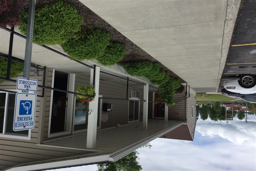 a rendering of a building with plants on the roof