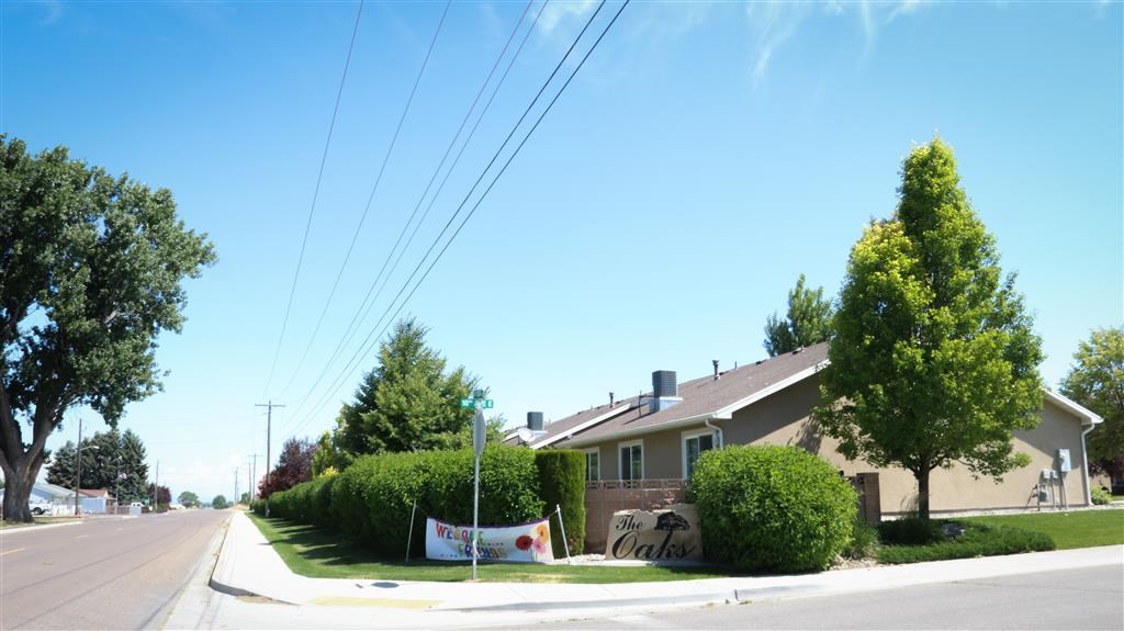 a house with graffiti on the side of the street