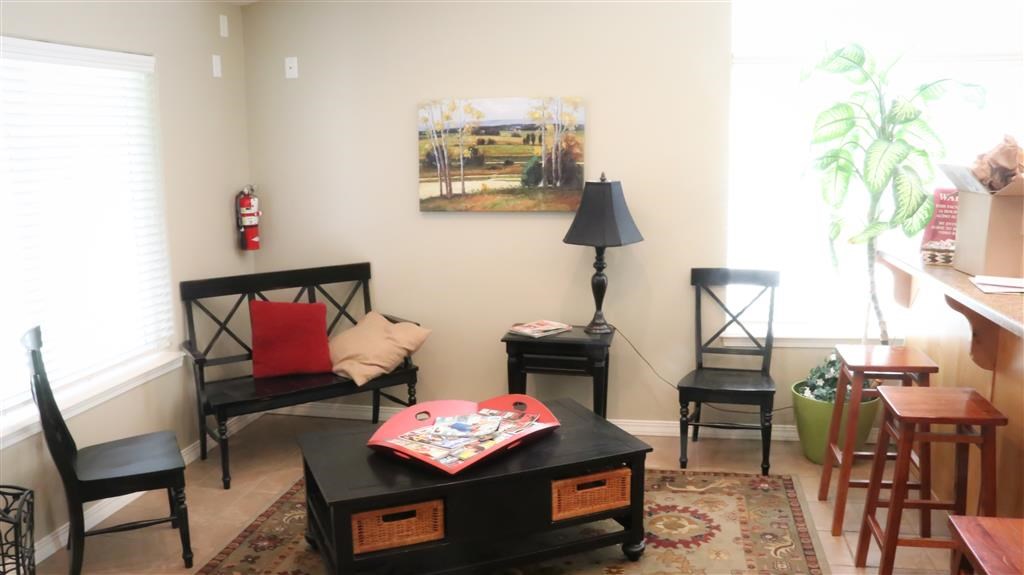 a living room with a coffee table and chairs