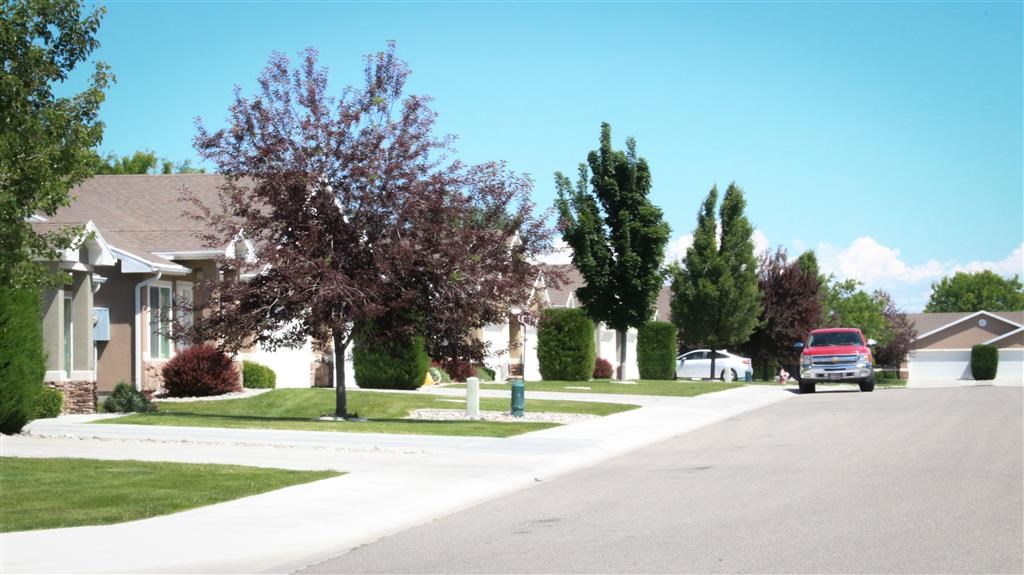 a red truck parked on a street in front of houses