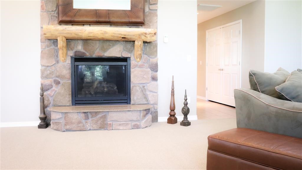 a living room with a fireplace and a leather couch