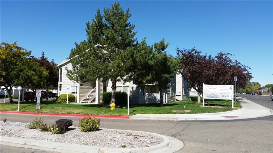 a yellow fire hydrant in front of a white house