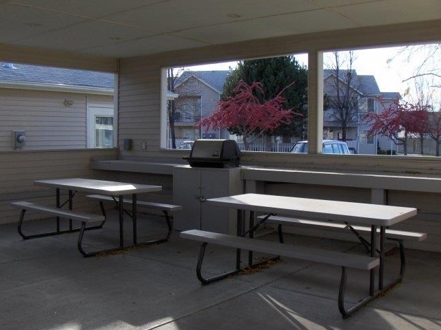 three picnic tables sitting in front of a building