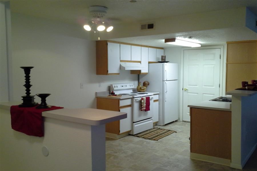 a kitchen with a stove and a refrigerator