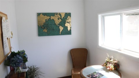 a dining room with a table and a map on the wall
