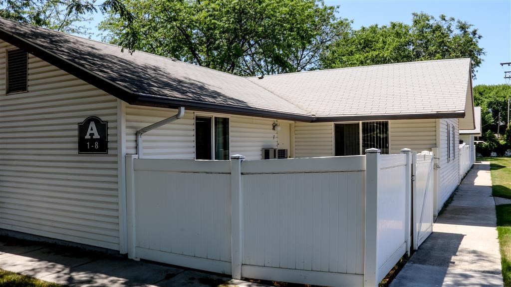 a white house with a white fence