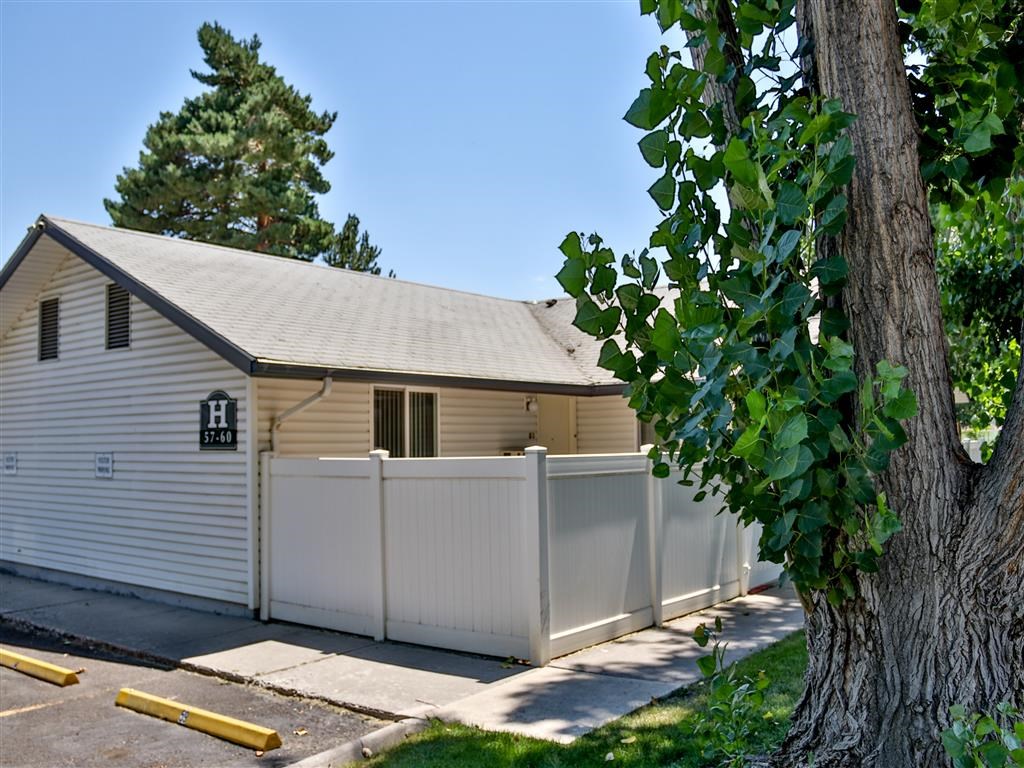 a white privacy fence in front of a white house