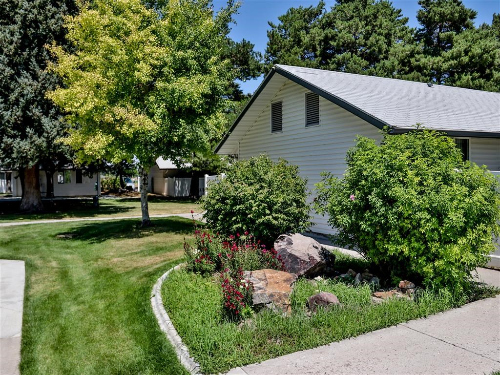 a garden in front of a white house