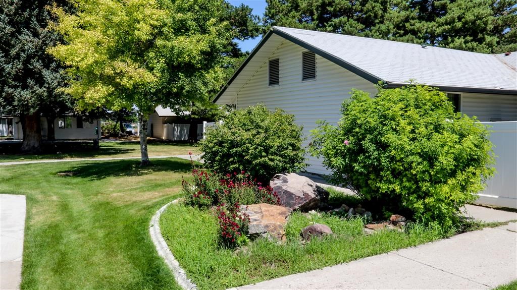 a white house with a garden in front of it
