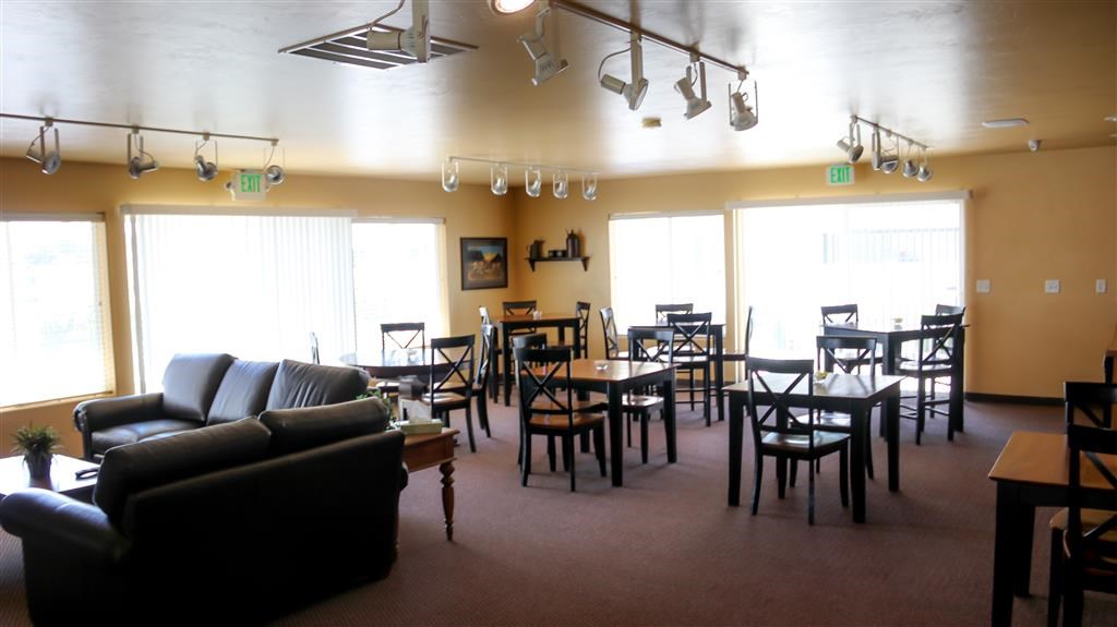 a living room and dining room with tables and chairs