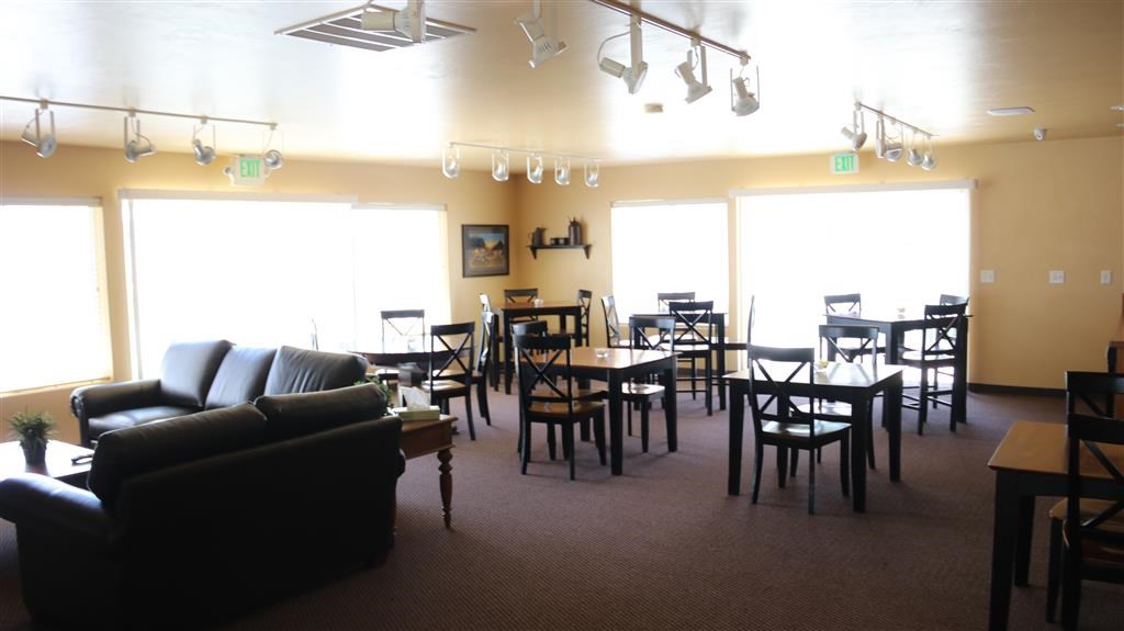 a living room and dining room with tables and chairs