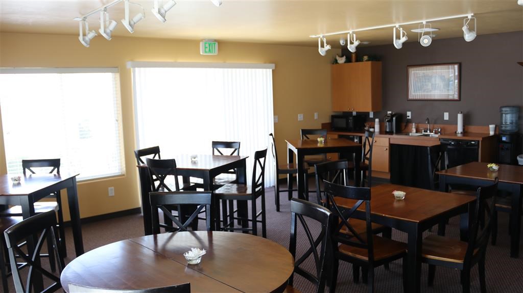 a dining room and kitchen with tables and chairs