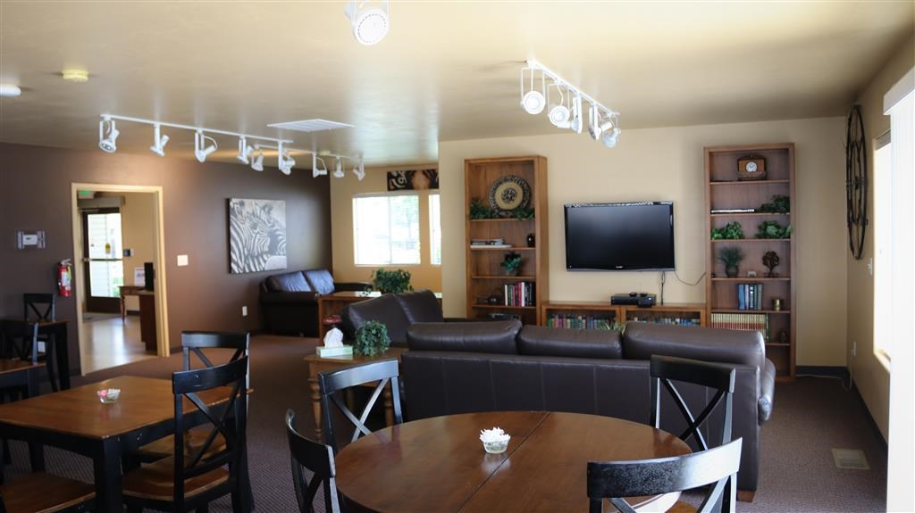 a living room with couches a table and a television