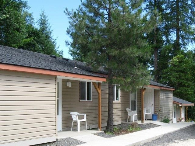 a small house with a tree in front of it