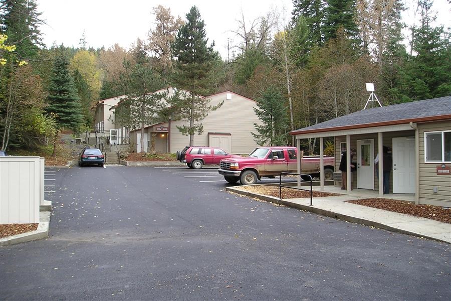 a street with cars parked in front of houses
