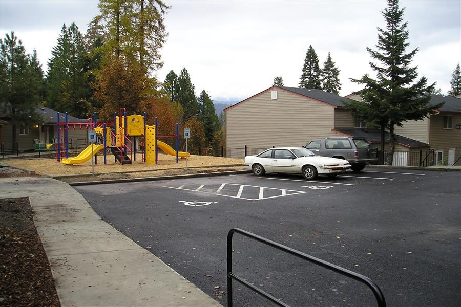 a playground and a car parked in a parking lot