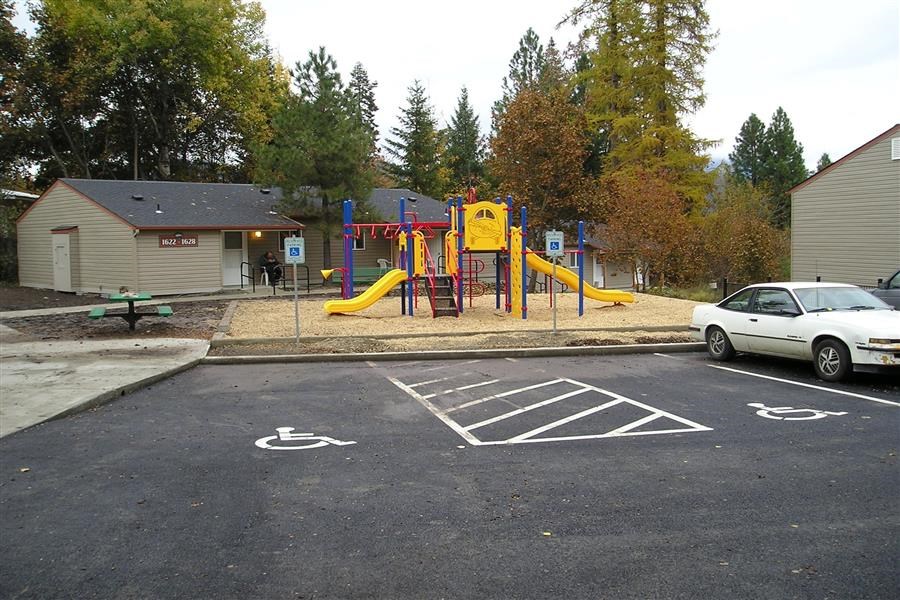a playground in a parking lot with a car