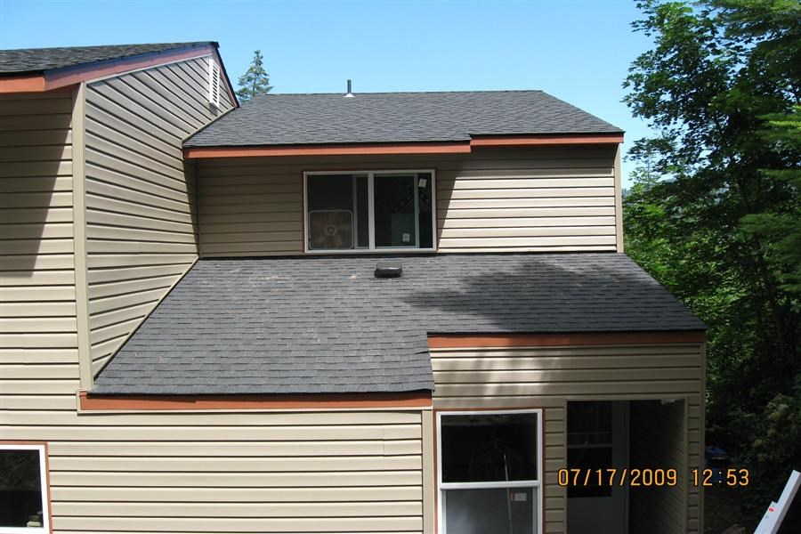 a house with a gray roof and a window