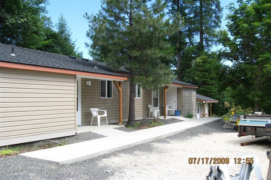 a small house with a yard and a garage