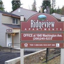 a sign for ridgeway apartments in front of a house
