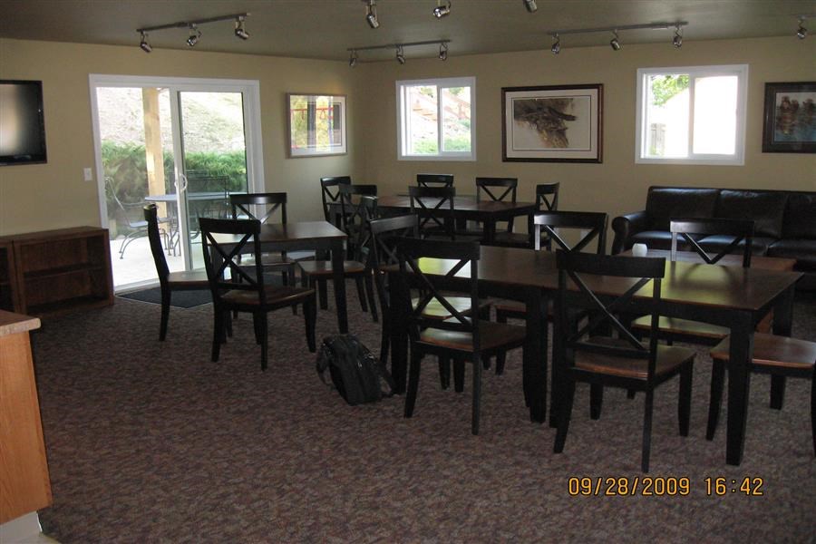 a dining room with tables and chairs and a tv