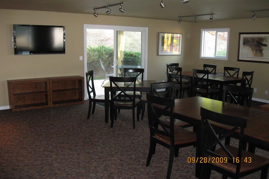 a dining room with tables and chairs and a television
