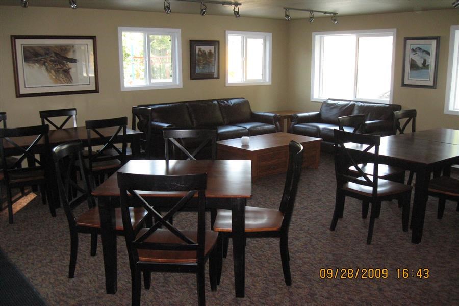 a living room with tables and chairs and leather furniture