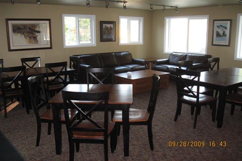 a living room with tables and chairs and leather furniture