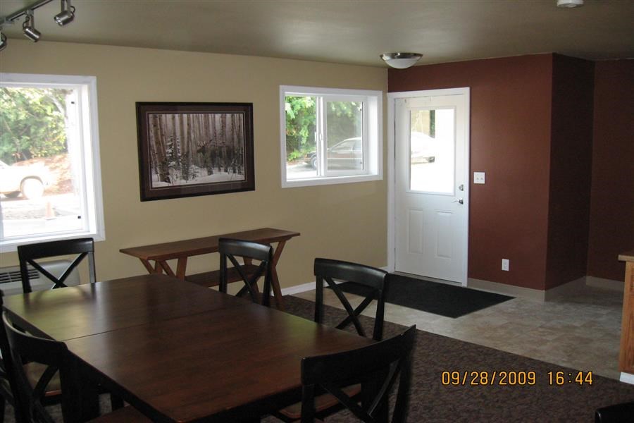 a dining room with a wooden table and chairs