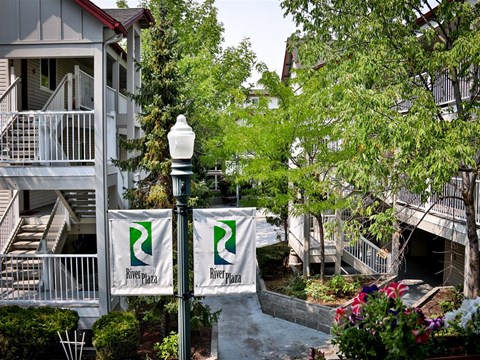 an apartment building with signs in front of it