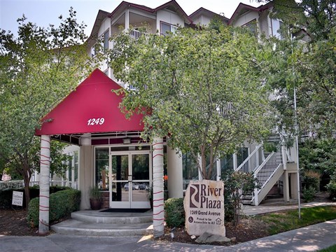 a building with a red roof and a sign in front of it