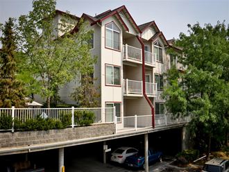 an apartment building with a parking ramp in front of it