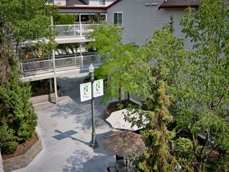 an aerial view of a courtyard with trees and a street sign