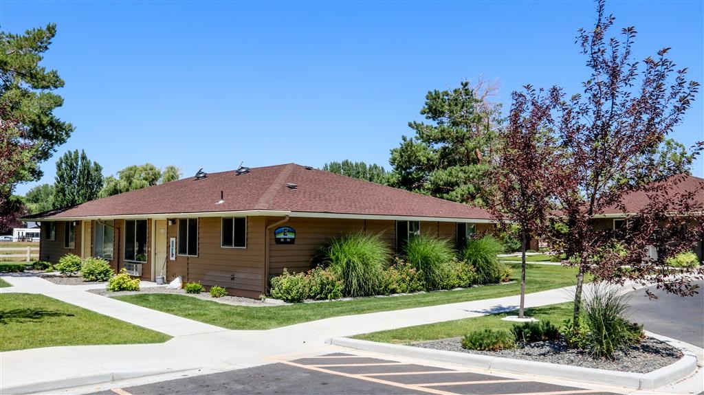 a brown house with a sidewalk in front of it