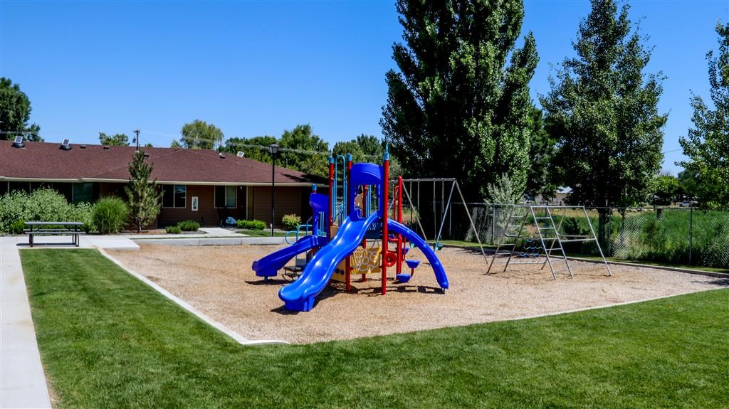 our apartments have a playground with slides and a picnic table