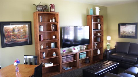 a living room with a television and a table
