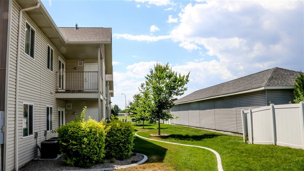 a white house with a yard and a white fence