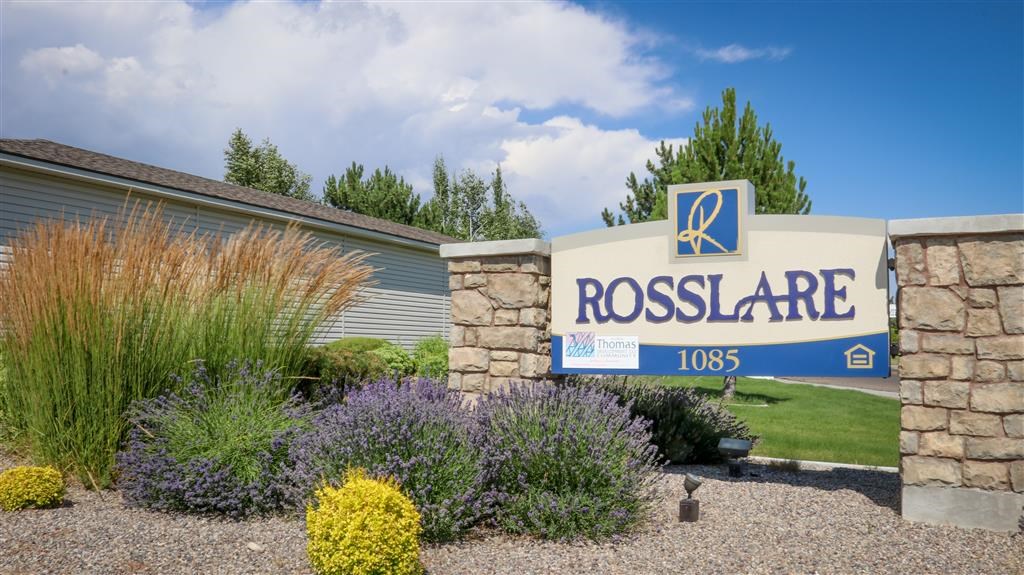 a building with a sign in front of a garden