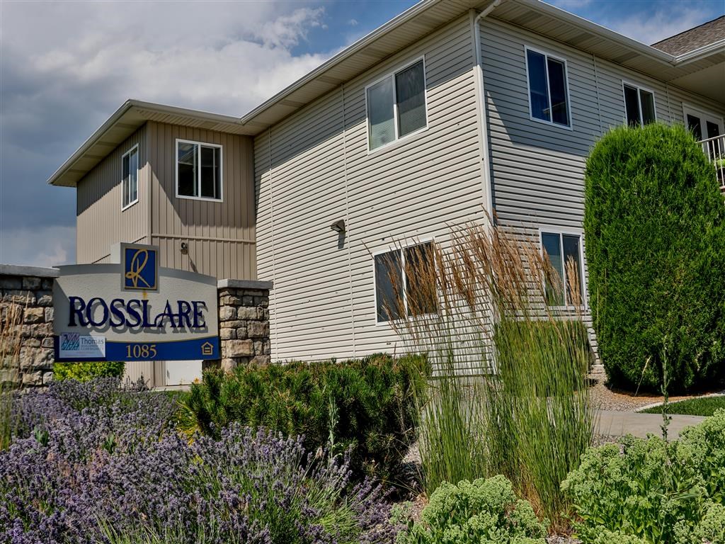 the front of a house with flowers in front of it