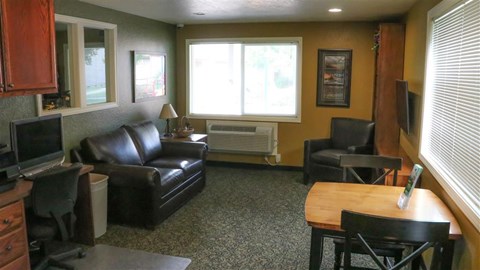 a living room with leather furniture and a tv