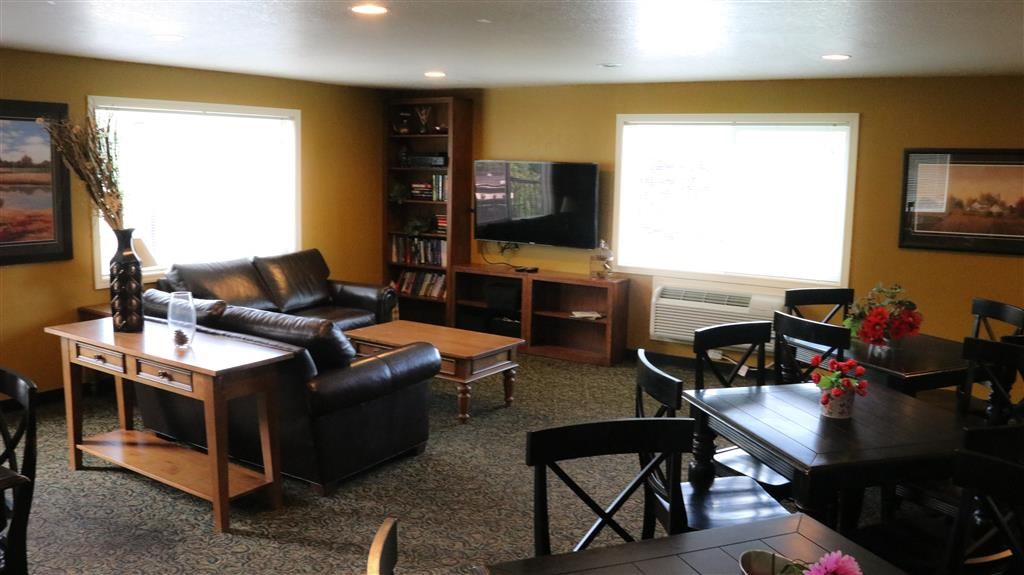 a living room with a table and chairs and a television